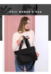 Detail of black nylon tote bag with adjustable shoulder strap and spacious interior