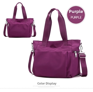 Detail view of purple nylon tote bag featuring front zipper and woven shoulder strap