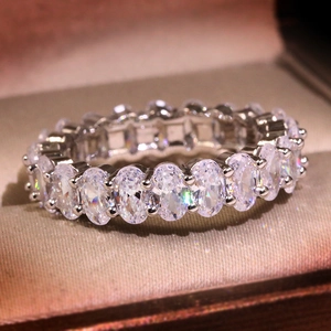 Macro shot of silver metal ring with sparkling oval cut cubic zirconia in a jewelry box