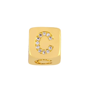 Macro detail of a gold-plated square charm featuring an inlaid zircon letter C for DIY jewelry