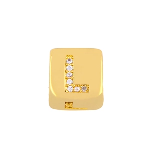 Macro shot of gold-plated square charm bead with white zircon pave setting letter L