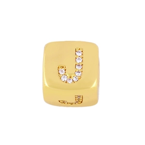 Close-up of gold cubic charm with sparkling zircon inlay showing the letter J detail