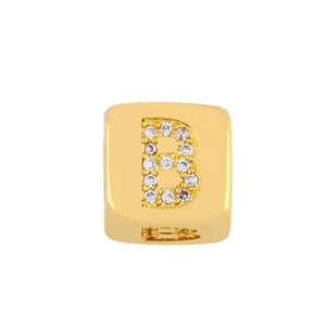 Macro shot of gold letter B charm bead with white cubic zirconia pavé for DIY bracelets