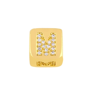 Macro shot of gold square bead featuring a crystal-encrusted letter M on its front face