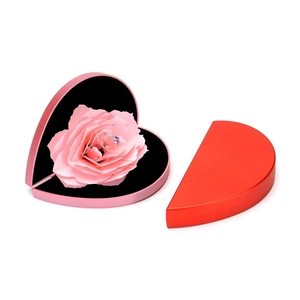 Detailed view of heart-shaped rotating ring box with a 3D blooming pink rose interior