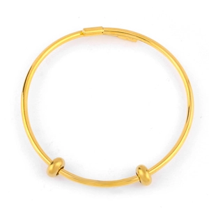 Close-up of adjustable gold bangle with sliding frosted beads and minimalist design