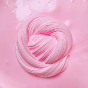 Detailed swirl of soft pink fluffy butter slime texture with glossy finish macro view