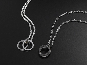 Detailed view of silver double ring pendants on interlocking hip hop necklaces