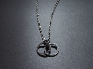 Detail of interlocking dark grey titanium circles on a geometric hip-hop style necklace