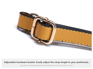 Detail of yellow leather strap with light gold metal buckle and precision stitching