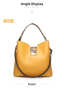 Detailed front view of yellow handbag with snake skin pattern handles and metal lock
