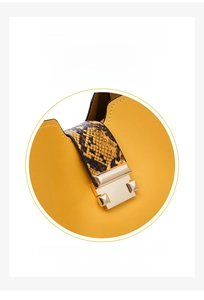 Detail of yellow and brown snakeskin handbag featuring a 90-degree rotating gold metal lock
