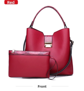 Front view of red tote bag set with snakeskin pattern details and gold hardware