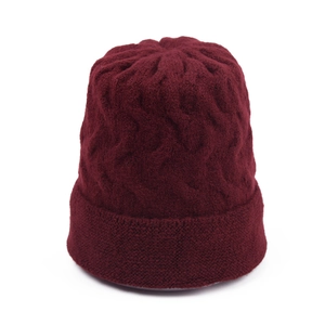 Close-up of wine red chunky knit beanie texture and ribbed cuff for winter