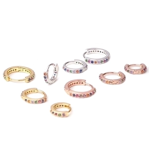 Three-color zircon hoop earrings in gold, silver, and rose gold on a clean white background