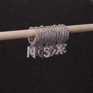 Silver letter hoop earrings featuring cubic zirconia charms for a sparkling jewelry look