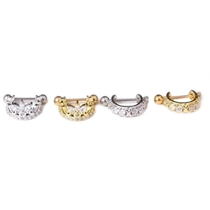 Golden and silver stainless steel crown nipple rings with zircon stones on white background