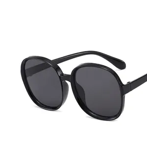 Classic round oversized sunglasses with glossy black frames and dark grey UV lenses