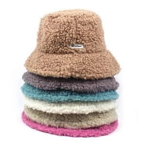 Close-up of colorful chenille fleece fisherman hats stacked to show soft plush texture