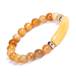 Macro detail of natural amber beads with silver spacers and curved bar on a beaded bracelet