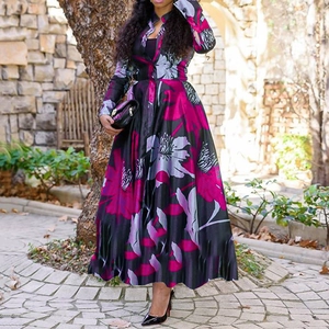 Close-up of floral print long dress featuring pink and grey flowers on black fabric