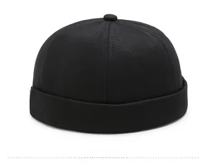 Side view of black brimless docker hat in twill cotton with six-panel construction