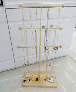 Three-tier gold metal necklace display stand with solid wood base for jewelry storage