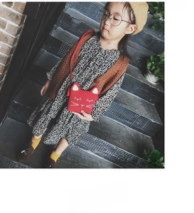 Detail shot of red cat-shaped shoulder bag for kids showing PU material and cute ears