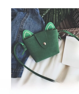 Detail of green cat-eared felt mini shoulder bag with metal snap button and strap