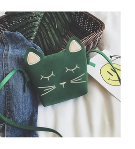 Detailed close-up of a green cat-shaped crossbody bag for girls with cute embroidery