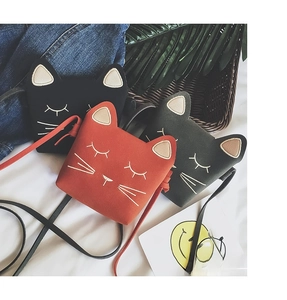 Detailed view of cat-shaped girl purses with cute ear details and embroidered faces