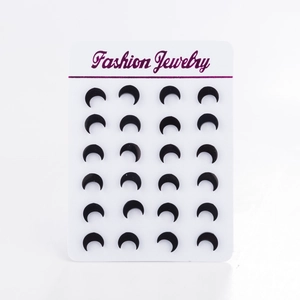 Set of 12 pairs of black crescent moon stud earrings displayed on a white jewelry card