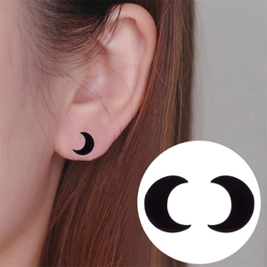 Minimalist black crescent moon stainless steel stud earrings shown on ear