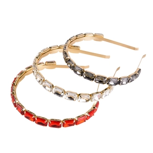 Detailed view of 3-piece thin metal headbands with red, clear and grey crystals