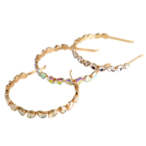 Detailed view of three thin metal headbands with champagne and clear crystal rhinestones