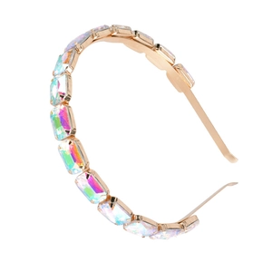 Close-up of golden headband with rectangular iridescent rhinestones on a white background
