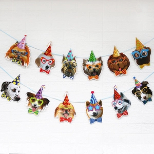 Happy birthday banner featuring twelve colorful cartoon dogs in party hats and glasses