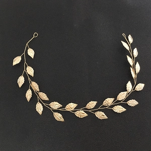 Close-up of golden leaf vine bridal headband showing metallic texture and detail