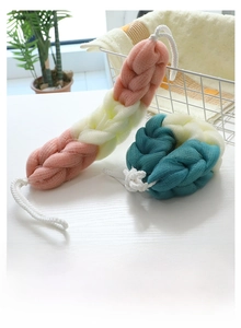 Macro view of multi-color long mesh back scrubber and loofah ball with white hanging ropes