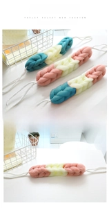 Detail of long braided bath loofah back scrubber with durable handles for shower use