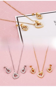 Detailed close-up of double-heart interlocking necklaces in gold and silver plating