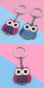 Close-up of colorful cartoon owl keychain with glossy enamel drip oil finish and metal ring