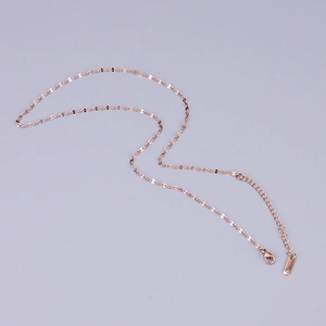 Detail of rose gold flat link chain necklace featuring secure lobster clasp and extension