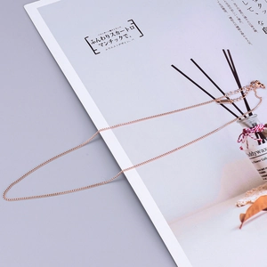 Close-up of rose gold minimalist chain necklace with lobster clasp and extension link