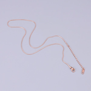 Detail of rose gold snake chain showing lobster clasp and K18 hallmark engraving