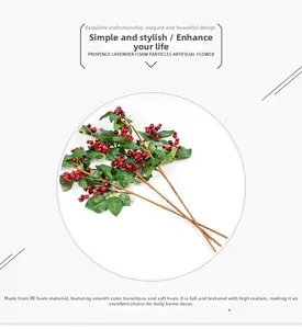 Close-up of artificial red berries made of PE foam with natural gradient color and green leaves