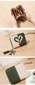 Detail view of women's mini heart purse with zip pocket and multiple card slots