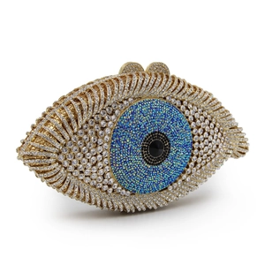 Detailed close-up of golden eye clutch bag with sparkling crystals and evil eye pattern