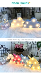 Close-up of cloud and unicorn LED night lights with warm glowing diodes on a soft rug