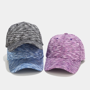 Detailed view of three space-dye baseball caps in black, blue, and purple breathable fabric